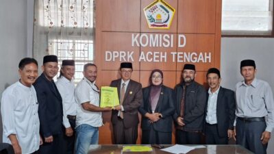 Ketua Umum Pasak Opat Nenggeri Linge, Zam Zam Mubarak, menyerahkan Naskah Akademik dan Draf Rancangan Qanun Adat Gayo kepada Ketua Badan Legislasi DPRK Aceh Tengah, Mukhlis, S.Pd., disaksikan Wakil Ketua II DPRK Aceh Tengah, Susilawati, Jumat (19/6/2026).